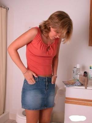 Amateur girl Karen hikes her denim skirt in the bathroom to expose her panties on justmyfans.pics