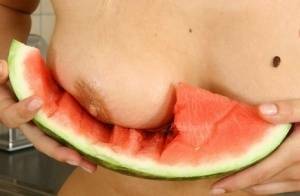 Blonde vixen Flower undressing in the kitchen to eat melon with bare big tits on justmyfans.pics