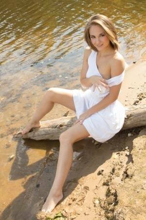 White teen of legal age shows off her naked body on a log that's beached on justmyfans.pics