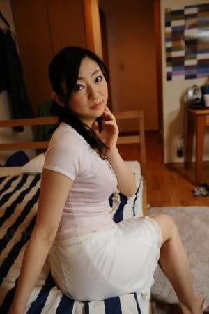 Slender mature Japanese woman Emiko Koike bends over to pose in white dress - Japan on justmyfans.pics