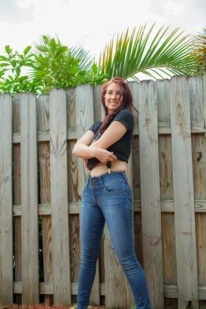 Hot redhead Andy Adams loses her t-shirt & jeans in the yard to pose naked on justmyfans.pics