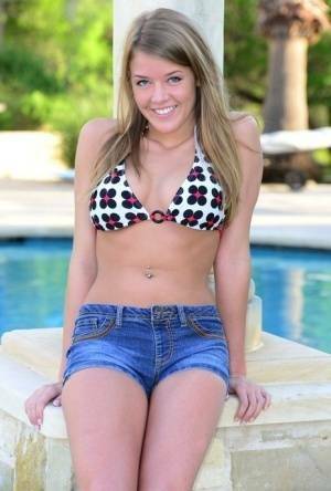 Cute teen Sophia Wood drops her shorts by the pool to toy with a vibrator on justmyfans.pics