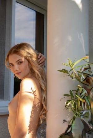 Young blonde Chanel Fenn shows her sexy ass while getting naked in a garden on justmyfans.pics