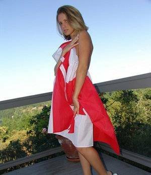 Canadian teen Karen wraps her naked body in a flag on her back deck on justmyfans.pics
