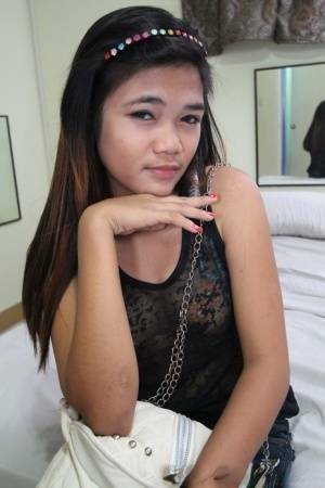 Young Filipina girl with a saucy look stands naked after undressing on justmyfans.pics
